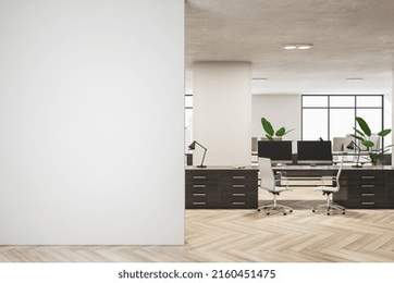 Front view on blank light wall in spacious stylish office with modern computers and plants on dark workspace tables on wooden floor. 3D rendering, mock up