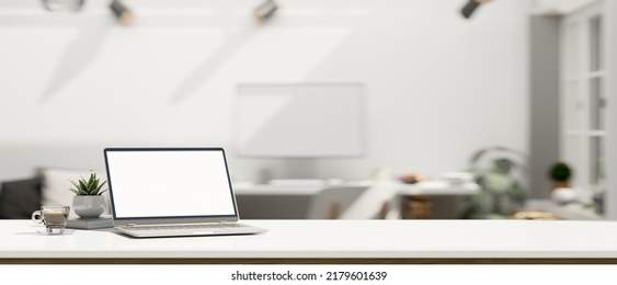 White workspace tabletop with open laptop blank screen mockup, a coffee cup, decor plant and copy space over blurred modern office background. 3d rendering, 3d illustration