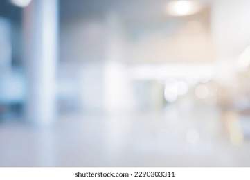 abstract blur modern interior inside entrance building of office in blue background with orange light effect concept