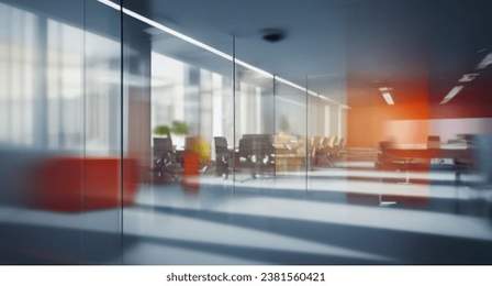 Beautiful blurred background of a modern office interior in gray tones with panoramic windows, glass partitions and orange color accents.