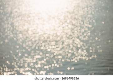 Blur tropical sunset beach with bokeh sun light wave abstract background. Copy space of outdoor summer vacation and travel adventure concept.