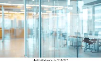 A blurry view of a modern office space through glass doors. Soft background