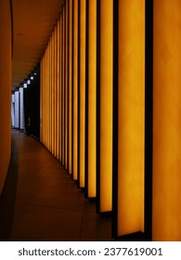 Colored corridor with yellow lights in the hall of a modern office building. Perspective view of abstract image