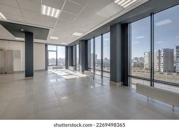 panorama view in empty modern hall with columns, doors and panoramic windows.