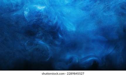 Shiny smoke. Glitter fluid. Ink water. Magic mist. Blue color particles texture paint vapor storm wave on dark black abstract background.