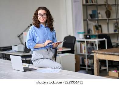 Smiling elegant confident middle aged woman standing in office, portrait.  Stock Photo by insta_photos